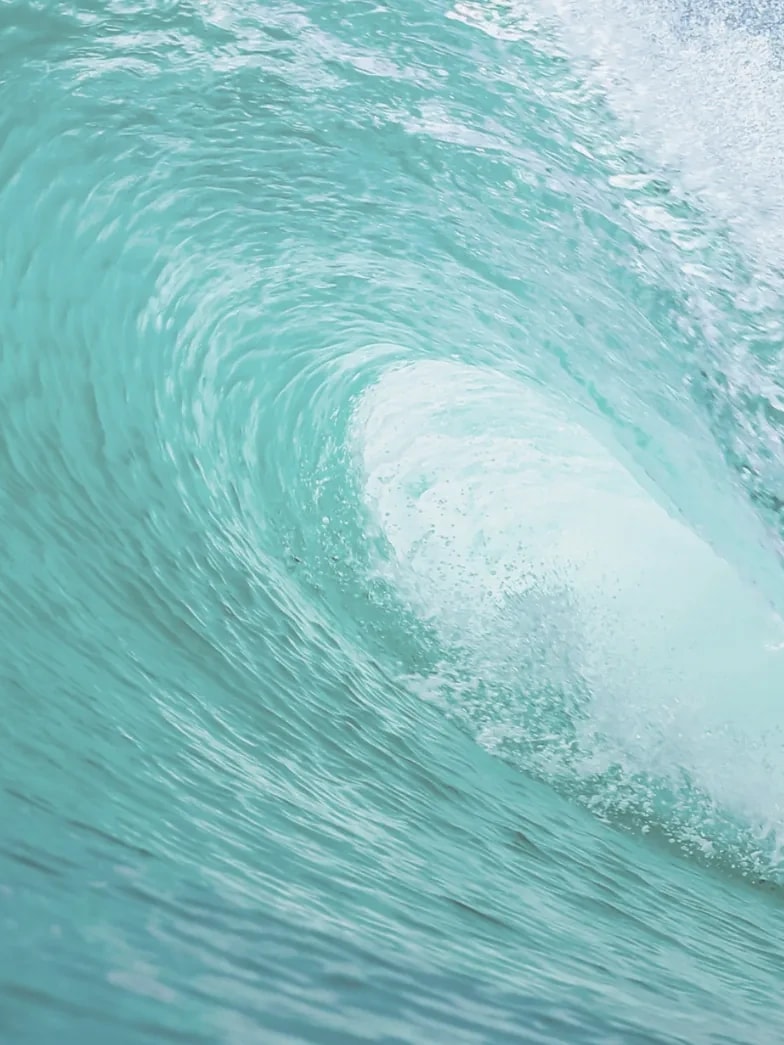 A breaking ocean wave curling into a barrel